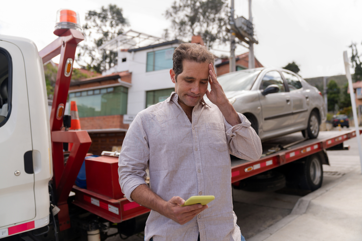 Man having problems with his car and calling roadside assistance Careless Driving in Minneapolis, MN